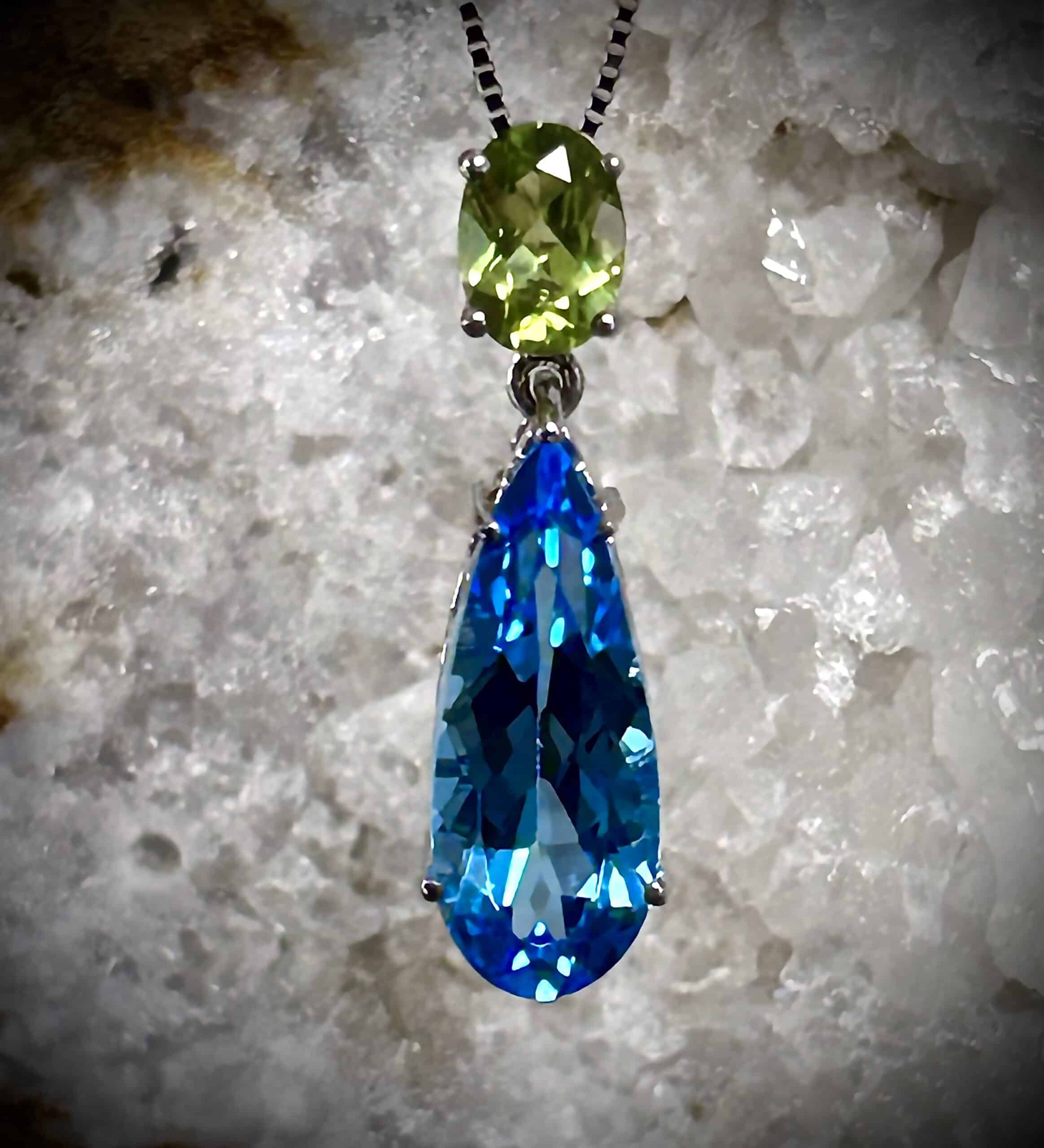 Blue Topaz And Peridot Pendant Set In A White Organic Background