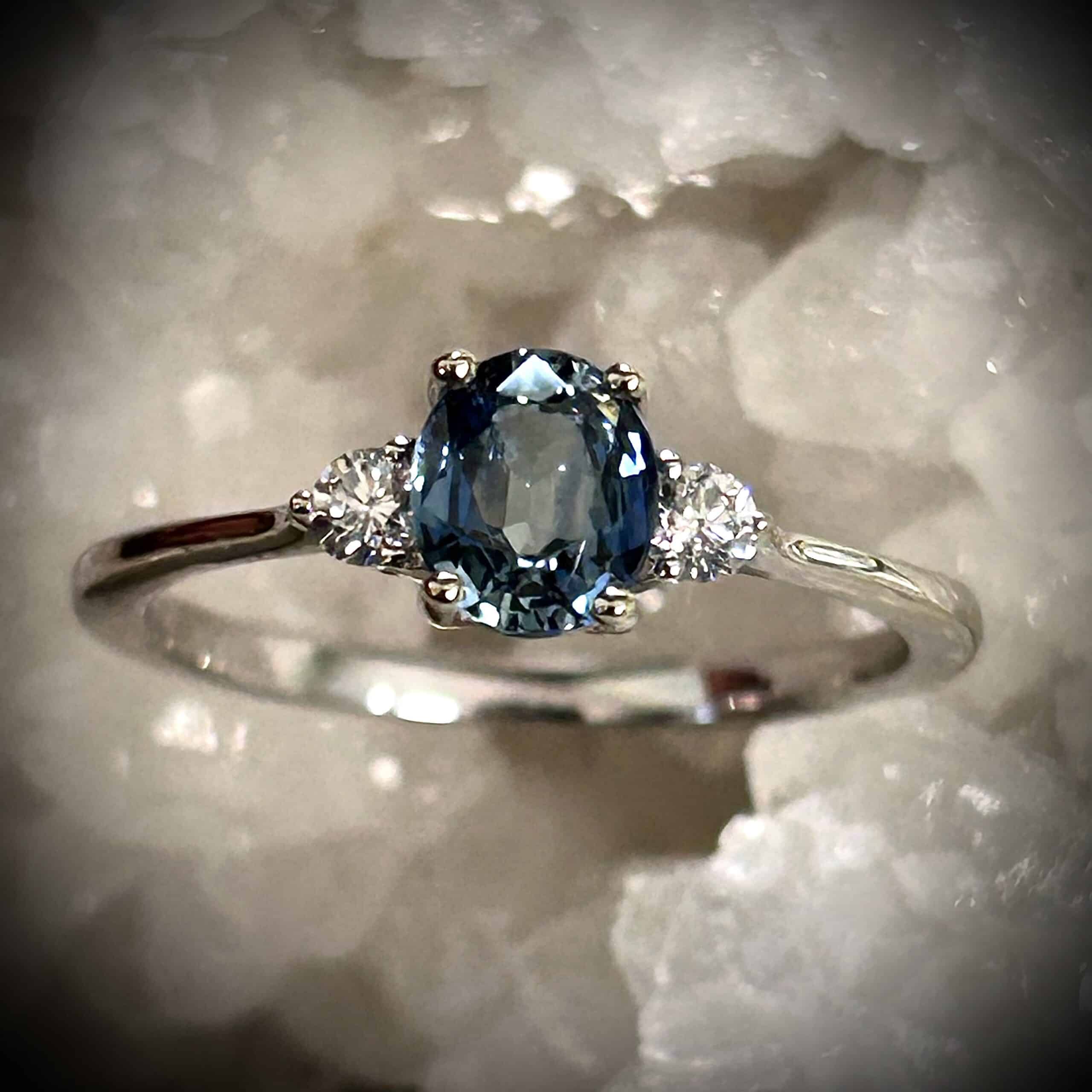 Natural .86Ct Natural Blue Sapphire Ring With Two Diamonds Set In 14K White Gold.