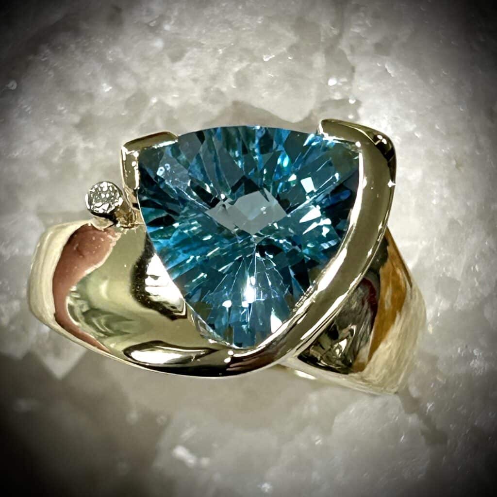 Radiant Blue Topaz Trillion Cut Ring Set In 14K Golds And Diamond Accent.