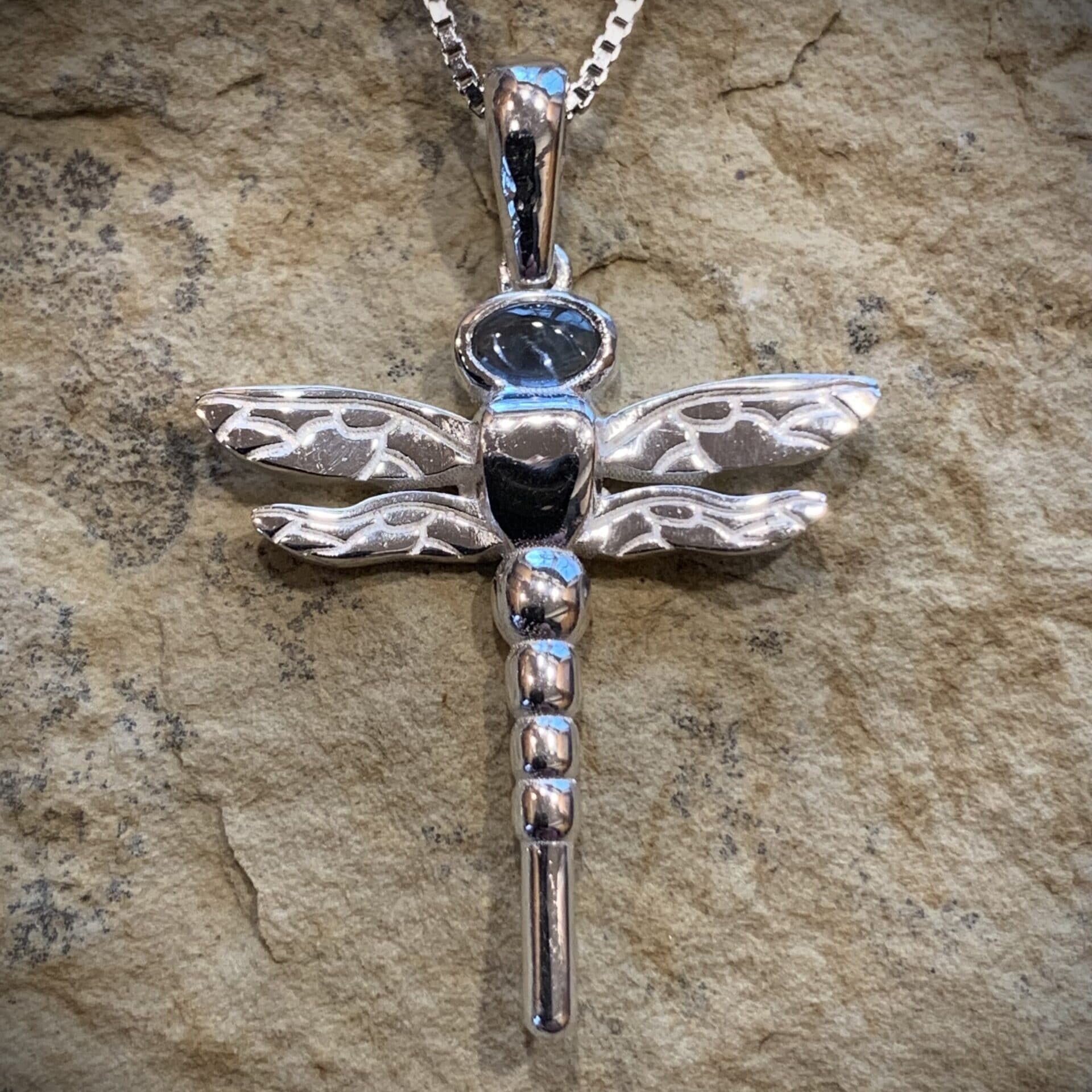 Close-Up Of High Polished Blue Topaz Cabochon Gemstone Set In Sterling Silver Dragonfly Pendant By River’s Edge Gems