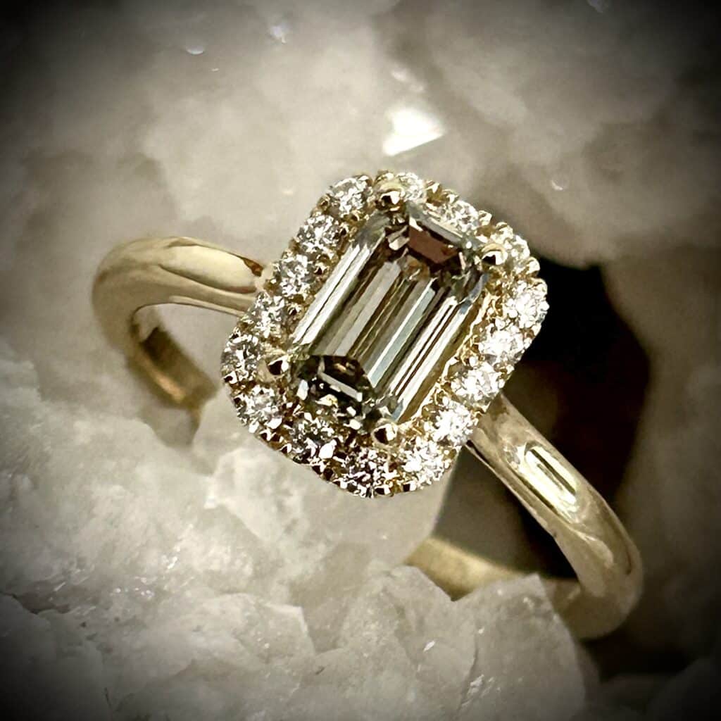Close Up Of Emerald Cut Grey Green Diamond Highlighting Precision Facets