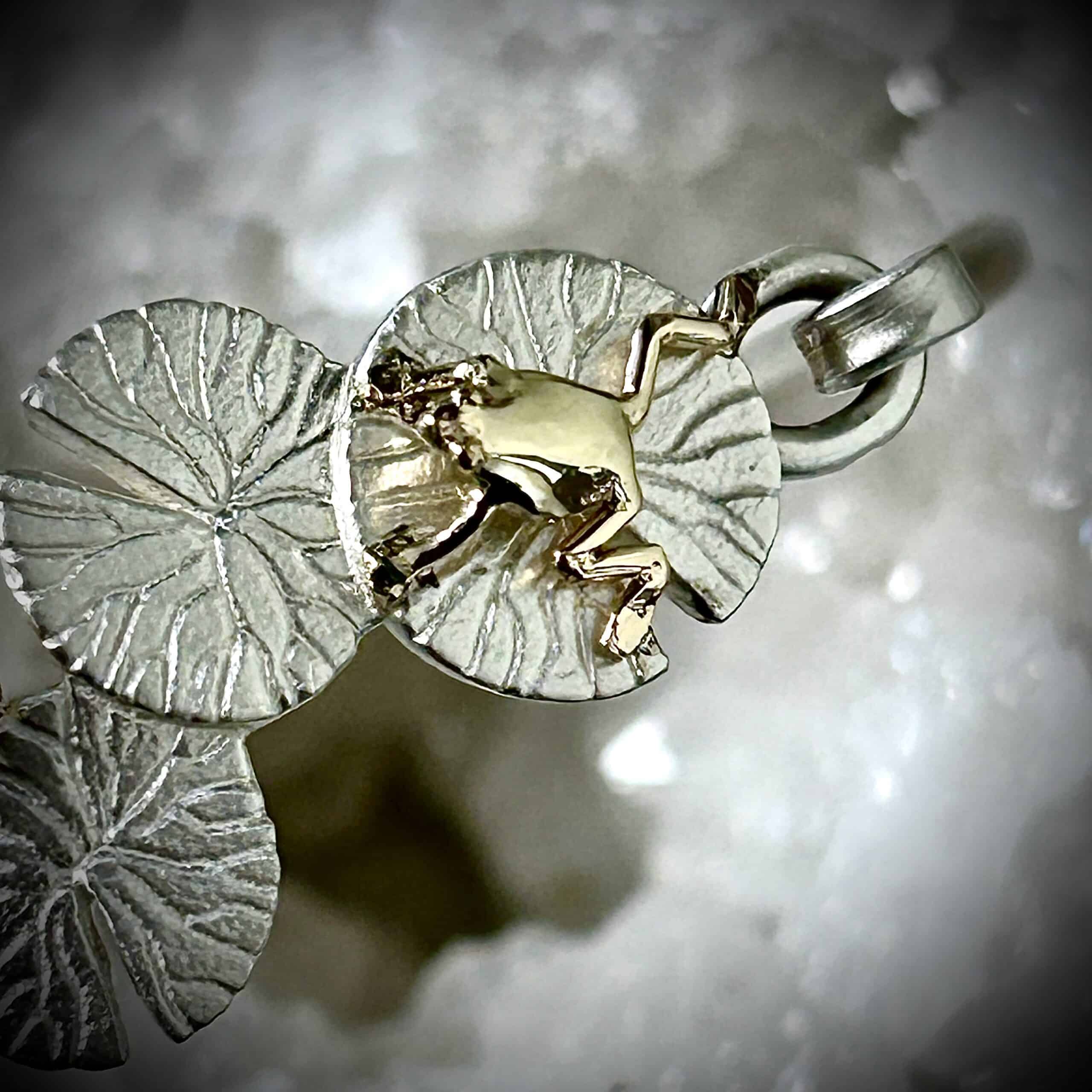 Custom Sterling Silver Lily Pad Bracelet With A Close Up Of The Gold Frog And Peridot Accent.