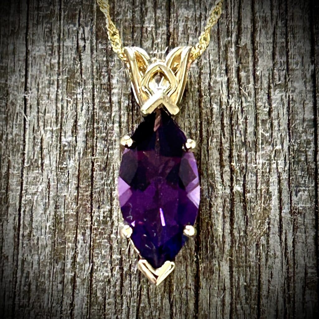 Marquise Cut Amethyst Pendant Showcasing Purple Gemstone Color And 14K Yellow Gold Scroll Design