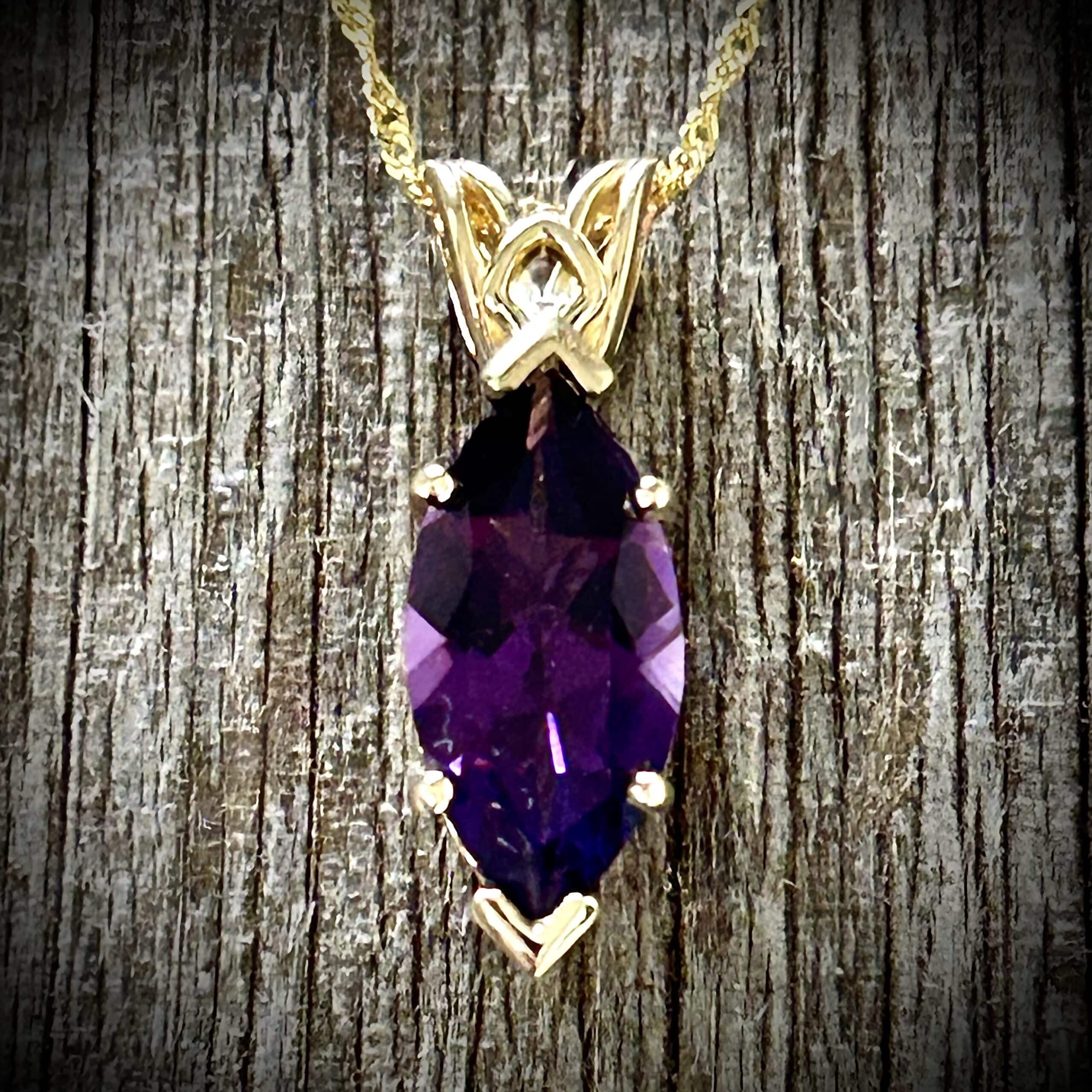 Marquise Cut Amethyst Pendant Showcasing Purple Gemstone Color And 14K Yellow Gold Scroll Design