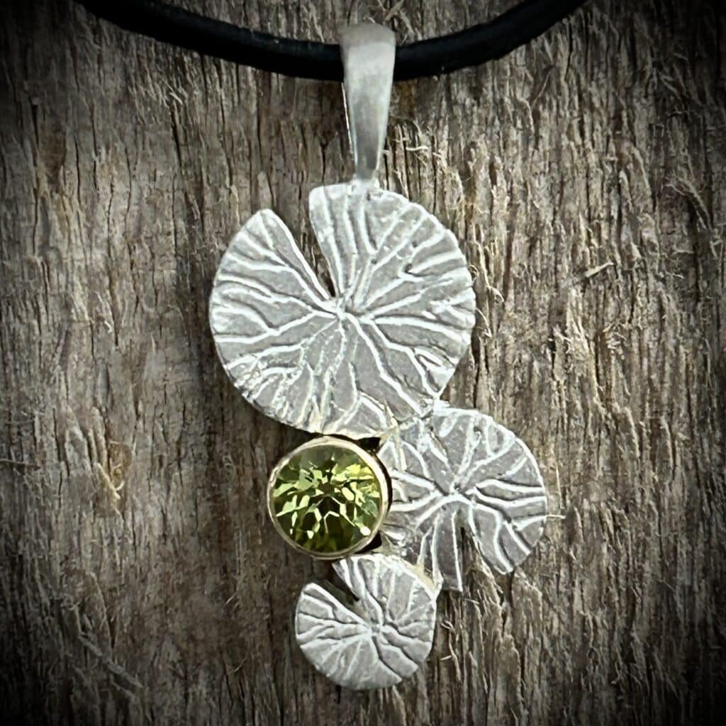 Peridot With 3 Lily Pads Pendant In Silver With 14K Gold Bezel. Nature Inspired By The Lily Pads In The Backwaters Of The Mississippi River.