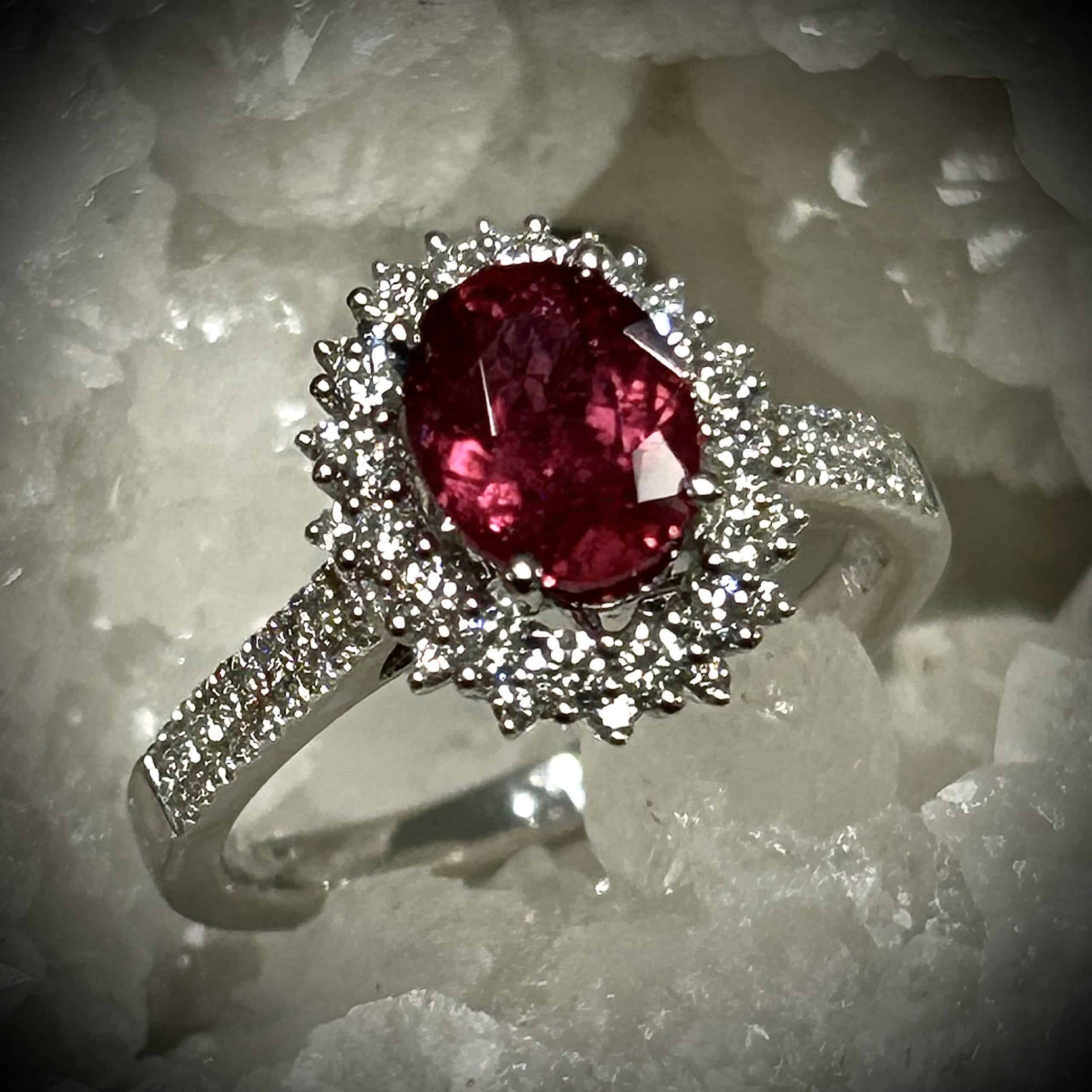 Close-Up Of Rubellite Tourmaline Gemstone Showing Deep Red Hue And Brilliant Facets Under Natural Light.
