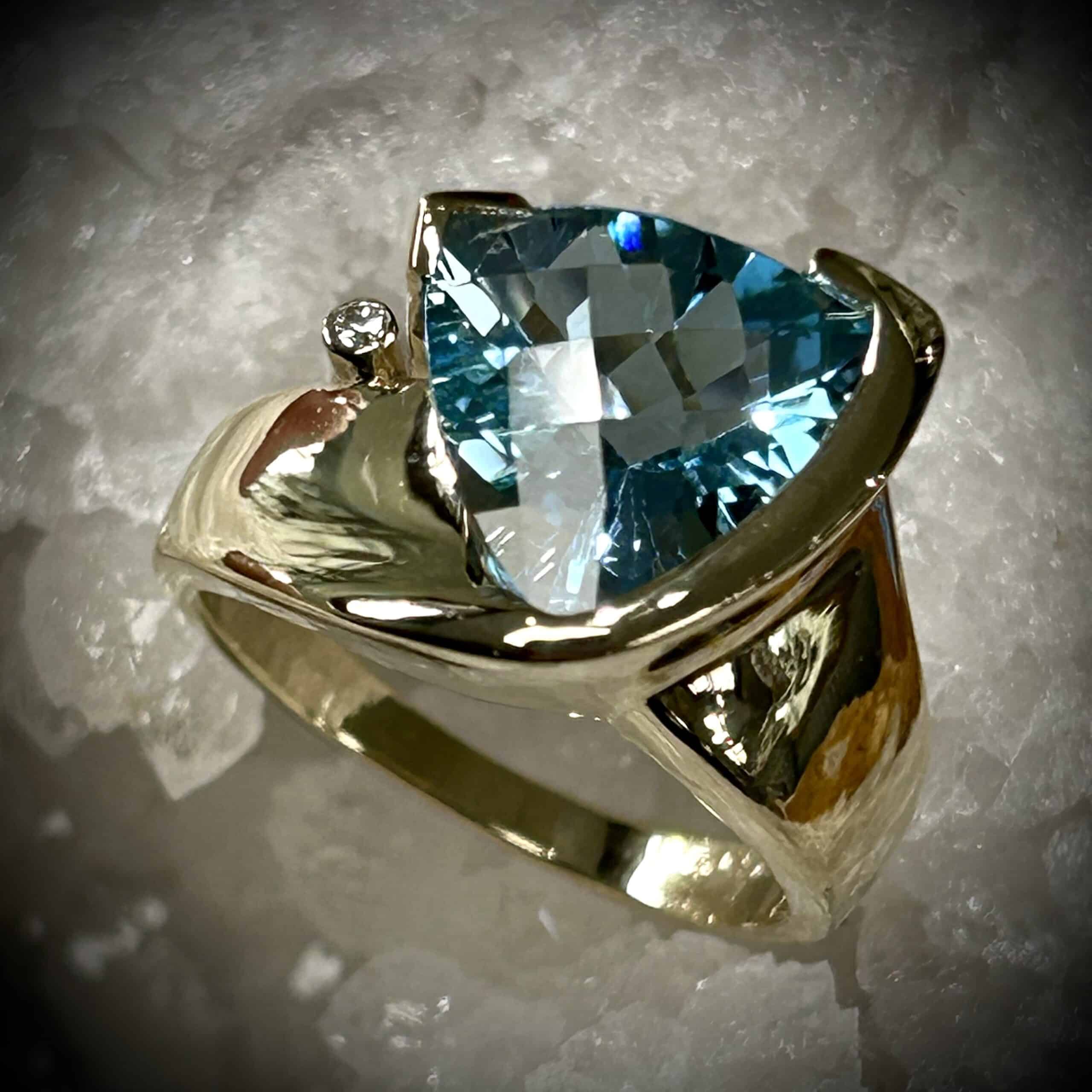 Blue Topaz Trillion Cut Gemstone With &Amp;Quot;Checkerboard&Amp;Quot; Cut Top. D Ring In Yellow Gold With A White Gold Accent Setting